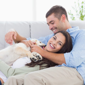 Happy couple with dog enjoying clear vision after LASIK